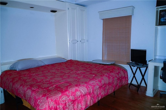 bedroom featuring wood finished floors