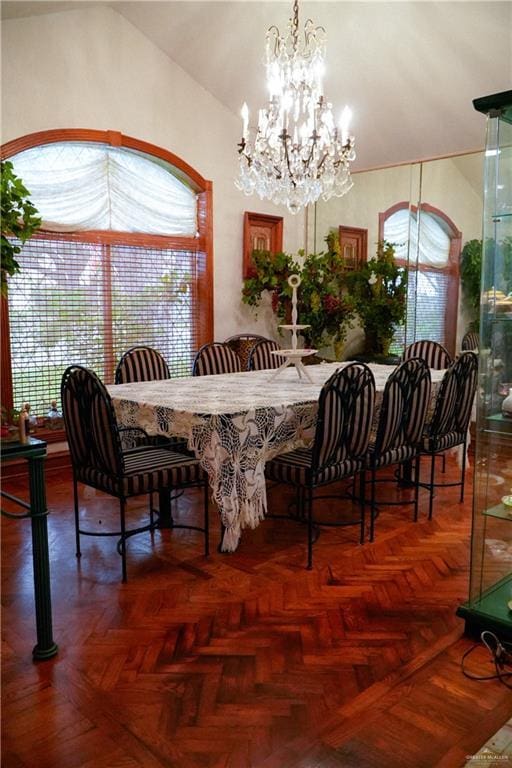 dining area with a chandelier, lofted ceiling, and plenty of natural light