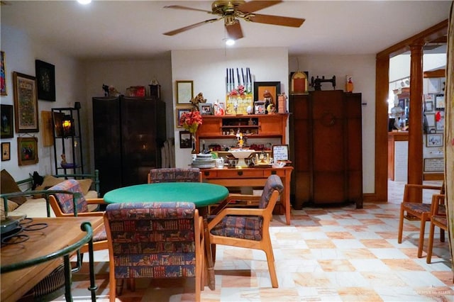 dining area with ceiling fan, ornate columns, and light flooring