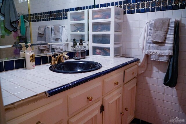 bathroom featuring tile walls and vanity