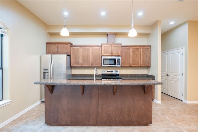 2815 Mimosa St Unit 6, Mission, TX 78574 - kitchen with stainless steel appliances, a kitchen bar, light tile patterned flooring, dark stone counters, and hanging light fixtures