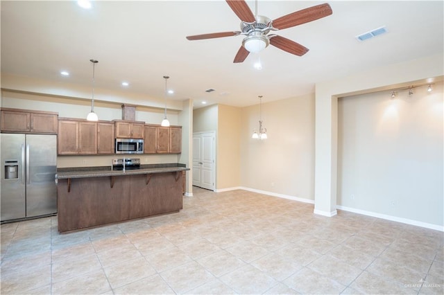 2815 Mimosa St Unit 6, Mission, TX 78574 - kitchen featuring stainless steel appliances, a breakfast bar, an island with sink, recessed lighting, and ceiling fan