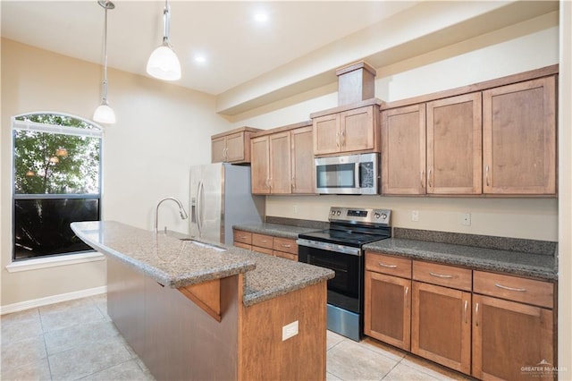 2815 Mimosa St Unit 6, Mission, TX 78574 - kitchen featuring stainless steel appliances, a kitchen island with sink, a sink, and light tile patterned floors