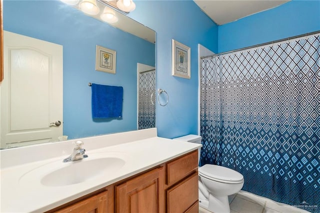 bathroom featuring tile patterned flooring, vanity, toilet, and walk in shower