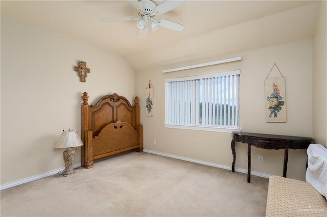 sitting room with ceiling fan, light colored carpet, and vaulted ceiling