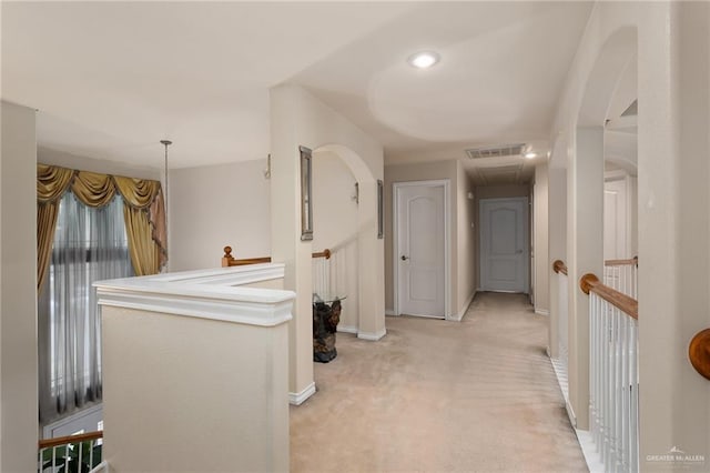 hallway with light colored carpet