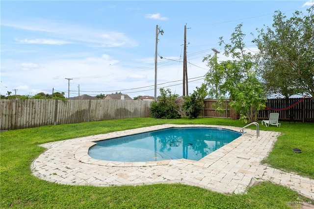 view of pool with a yard and a patio area