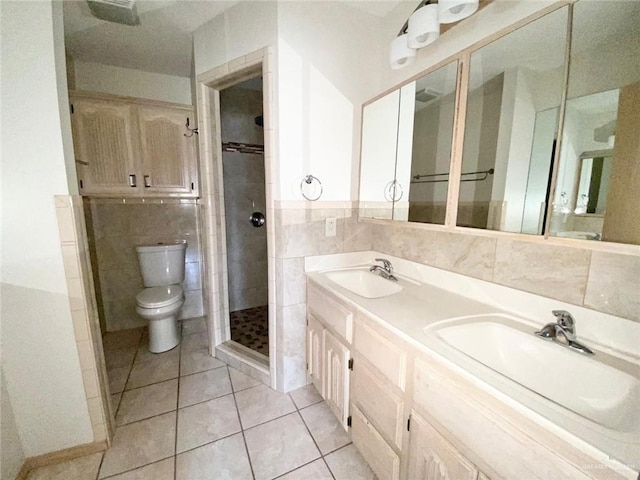 full bath featuring toilet, a stall shower, a sink, and tile walls