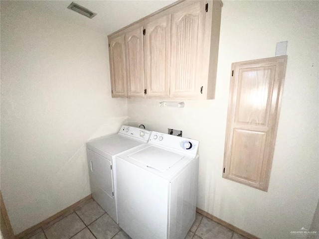 laundry room featuring cabinet space, light tile patterned floors, visible vents, and independent washer and dryer