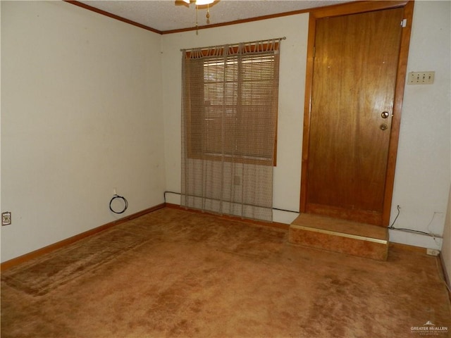 empty room featuring carpet floors, ceiling fan, and ornamental molding