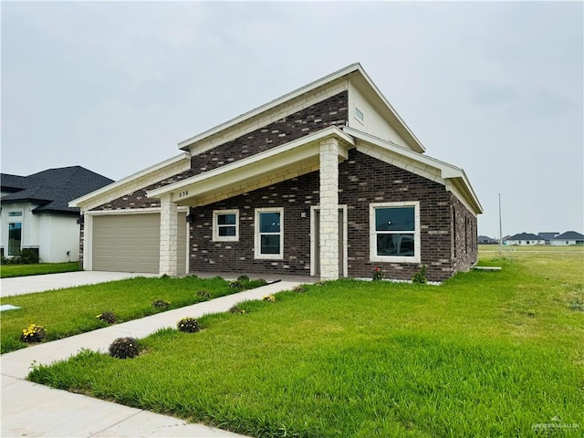 view of front of property with a front yard and a garage