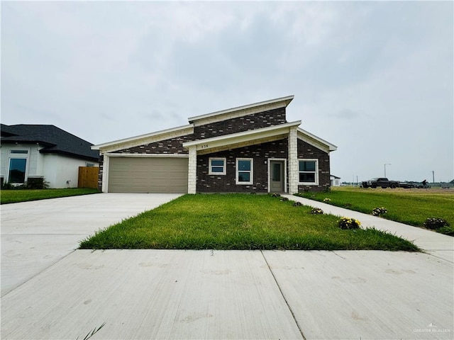 view of front of property with a garage and a front lawn