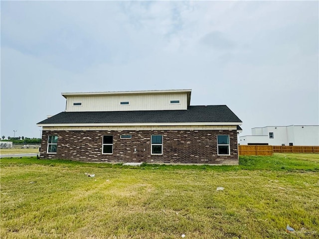 back of house with a lawn