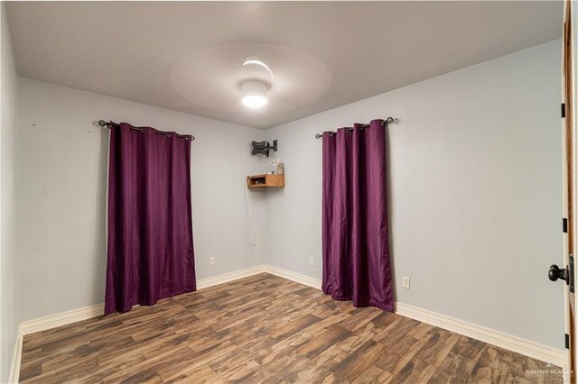 empty room featuring wood-type flooring