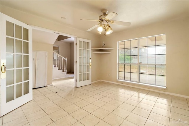 empty room featuring light tile patterned floors, french doors, and ceiling fan