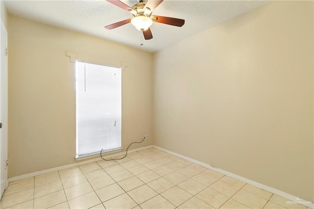 unfurnished room with light tile patterned floors, a textured ceiling, and ceiling fan