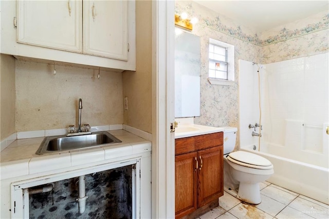 full bathroom featuring washtub / shower combination, vanity, toilet, and tile patterned flooring