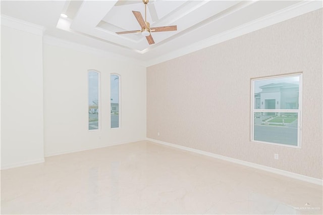 unfurnished room with a raised ceiling, ceiling fan, and ornamental molding