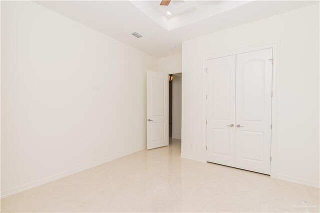 unfurnished bedroom featuring ceiling fan and a closet