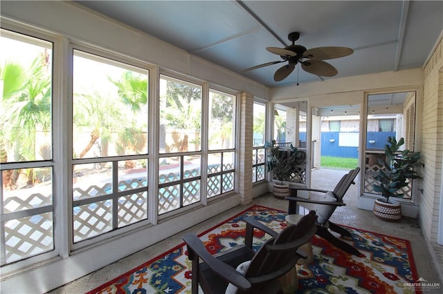 sunroom / solarium featuring plenty of natural light and ceiling fan