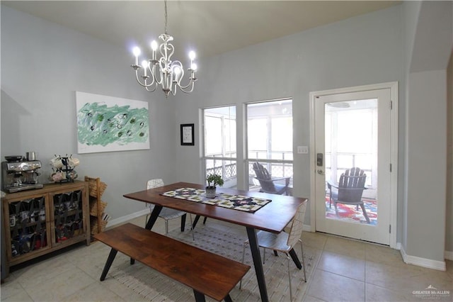 tiled dining space with a chandelier