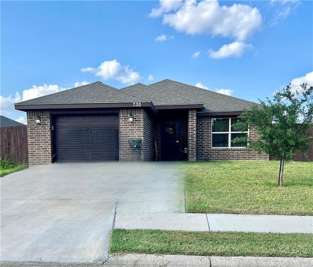 view of front of property with a garage and a front lawn