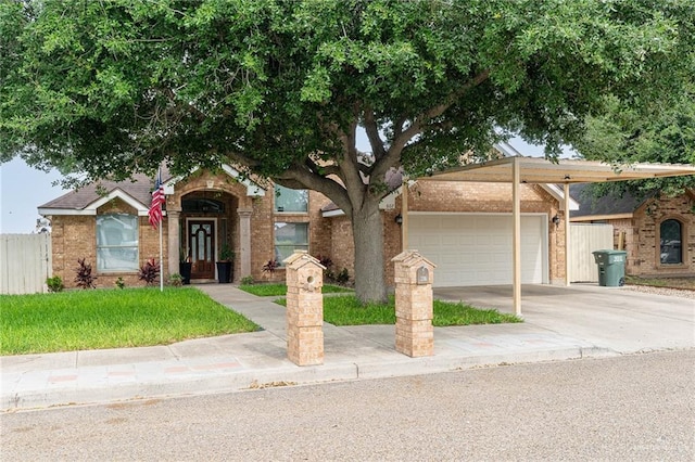 607 Via Cantera Dr, San Juan, TX 78589 - view of front of house with a garage, concrete driveway, and brick siding