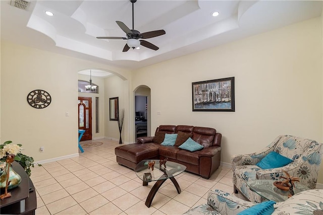 607 Via Cantera Dr, San Juan, TX 78589 - living area with arched walkways, light tile patterned flooring, a raised ceiling, baseboards, and recessed lighting