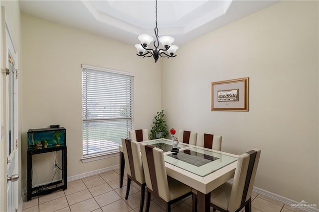 607 Via Cantera Dr, San Juan, TX 78589 - dining room with a chandelier, light tile patterned floors, baseboards, and a tray ceiling
