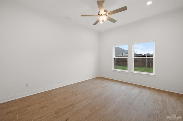 unfurnished room with light wood-type flooring and ceiling fan