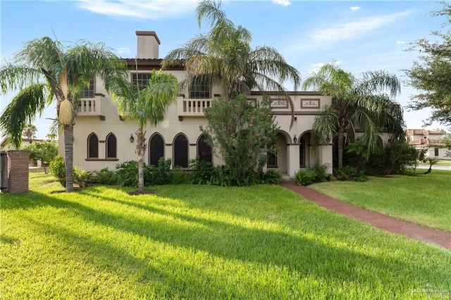 mediterranean / spanish-style home with a front lawn