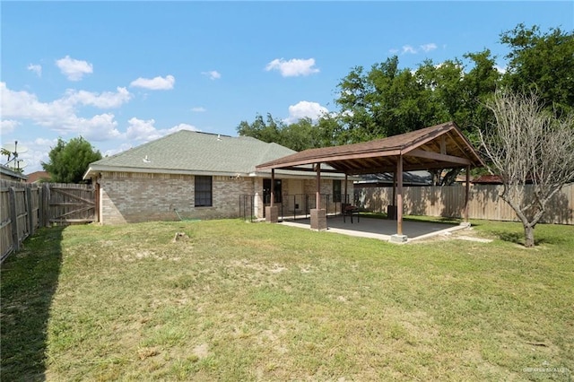 back of property featuring a gazebo, a patio area, and a yard