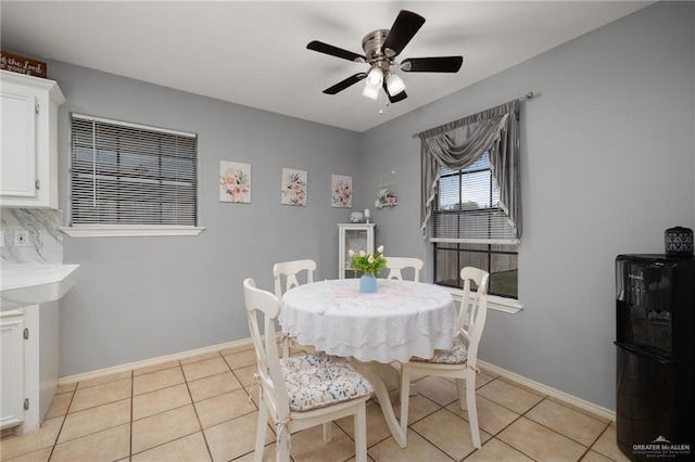 tiled dining room featuring ceiling fan