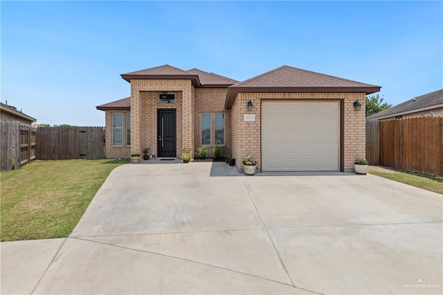 9713 Alexis Ave, Harlingen, TX 78552 - view of front facade with brick siding, driveway, and an attached garage