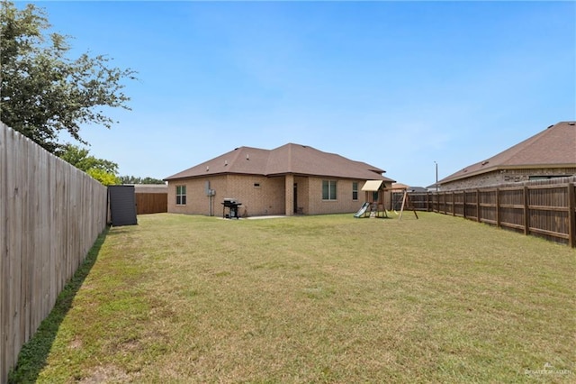 9713 Alexis Ave, Harlingen, TX 78552 - back of property featuring a playground and brick siding