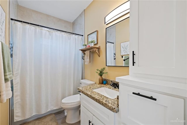 9713 Alexis Ave, Harlingen, TX 78552 - full bath with vanity, toilet, and wood finished floors