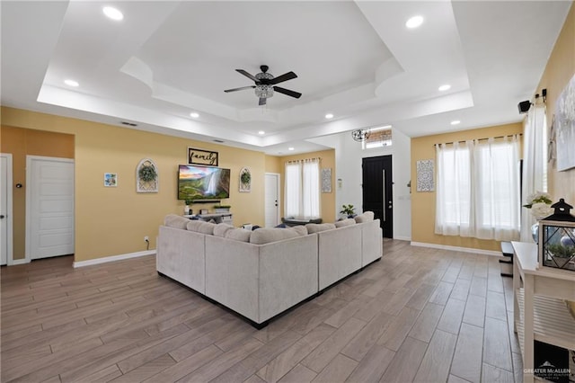 9713 Alexis Ave, Harlingen, TX 78552 - living area featuring a tray ceiling, ceiling fan, light wood-style flooring, recessed lighting, and baseboards