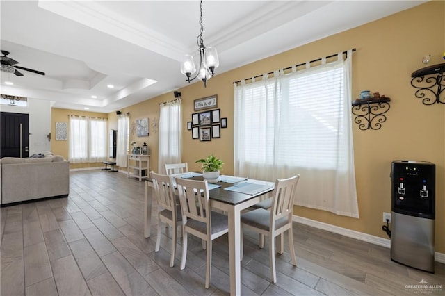 9713 Alexis Ave, Harlingen, TX 78552 - dining room with a raised ceiling, wood finished floors, a chandelier, recessed lighting, and ceiling fan