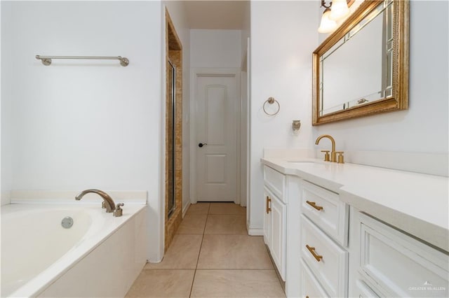 full bath featuring tile patterned flooring, a garden tub, vanity, and an enclosed shower