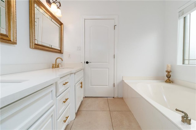 bathroom with double vanity, a sink, a wealth of natural light, and tile patterned floors