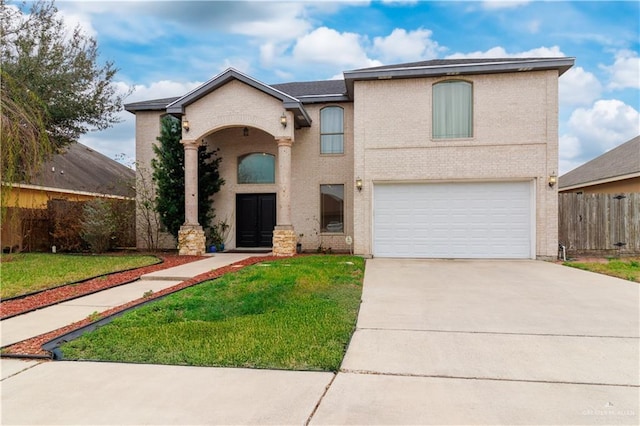 traditional home with a garage, brick siding, fence, driveway, and a front yard