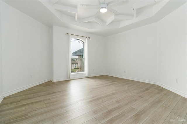 unfurnished room with light wood finished floors, baseboards, coffered ceiling, ceiling fan, and beam ceiling