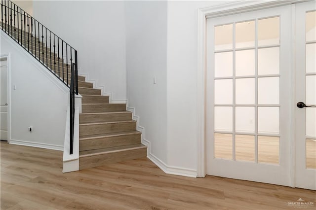 stairs with baseboards and wood finished floors