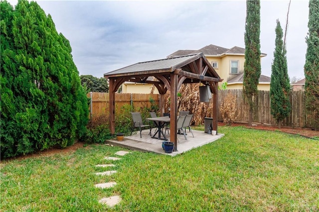 view of yard featuring a patio area, a fenced backyard, and a gazebo