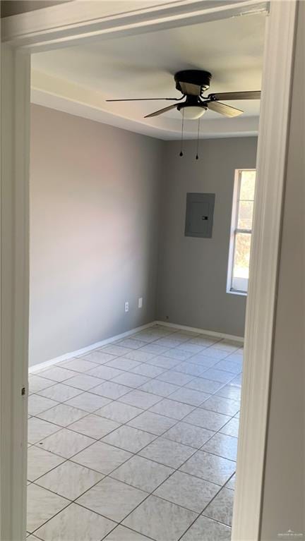 tiled spare room featuring electric panel and ceiling fan