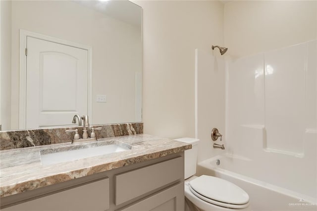 full bathroom featuring shower / bath combination, vanity, and toilet