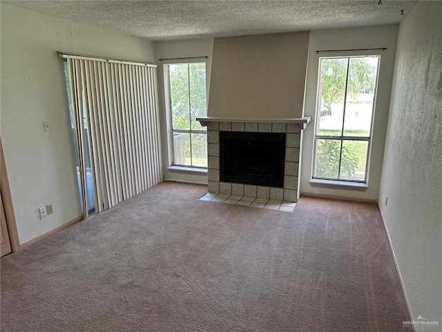 2901 Central Blvd Unit 807, Brownsville, TX 78520 - unfurnished living room featuring a textured wall, a textured ceiling, carpet flooring, and a fireplace