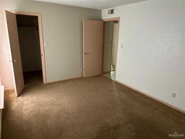 2901 Central Blvd Unit 807, Brownsville, TX 78520 - unfurnished bedroom with carpet flooring, a textured ceiling, and baseboards