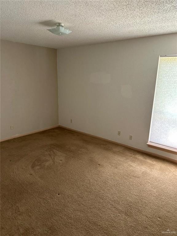 2901 Central Blvd Unit 807, Brownsville, TX 78520 - spare room with carpet floors, a textured ceiling, and baseboards