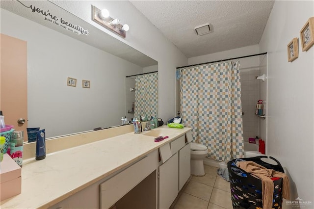 2901 Central Blvd Unit 807, Brownsville, TX 78520 - bathroom with vanity, toilet, a textured ceiling, tile patterned flooring, and shower / bath combination with curtain